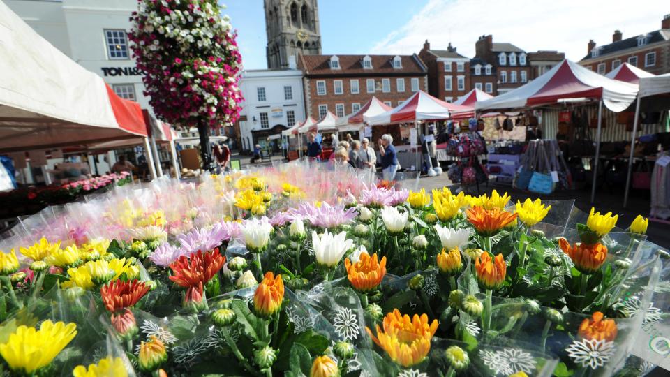 Newark Market with bright flowers at the front and the town square in the back