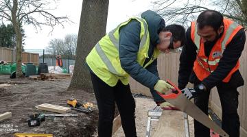 Volunteers working in a garden on a grey day