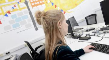 Council worker using a computer in an office