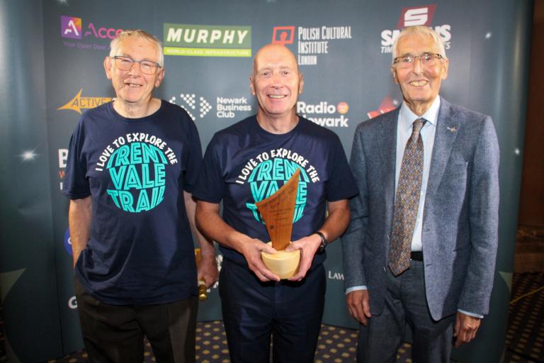 The Friends of Trent Vale Trail smiling holding awards trophy.