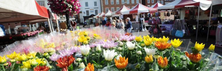 Newark Market with bright flowers at the front and the town square in the back